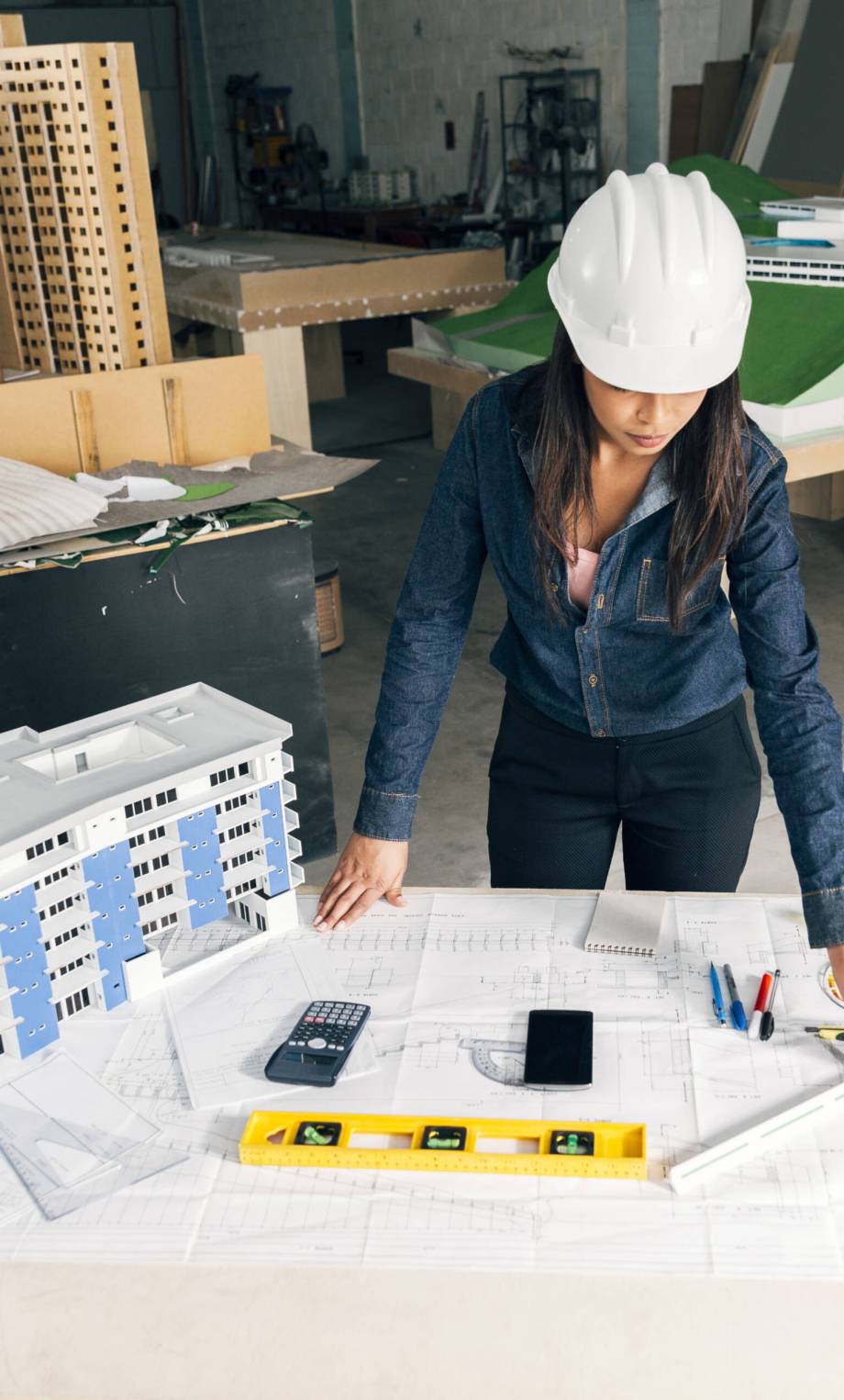 african-american-lady-safety-helmet-standing-near-model-building